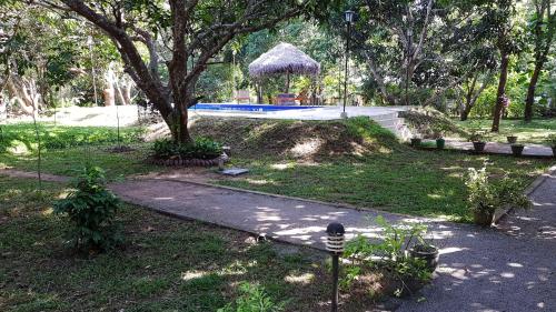 a park with a tree and a playground at Bissa Villa in Habarana