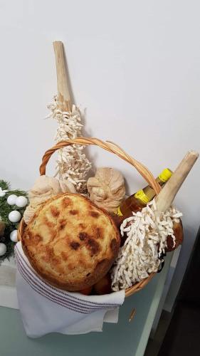 a basket of food with a pie and rice at Pensiunea Agroturistica Acvila Apusenilor in Vadu Moţilor