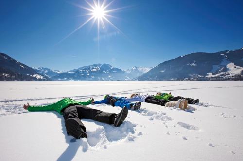 a group of people laying in the snow at Magali's, Bed & Breakfast - inclusive Summer Card in Zell am See