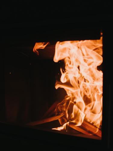 a close up of a fire in an oven at Alpin - Studios & Suites in Warth am Arlberg