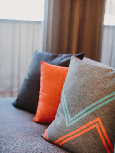 a couple of pillows sitting on top of a couch at Alpin - Studios & Suites in Warth am Arlberg