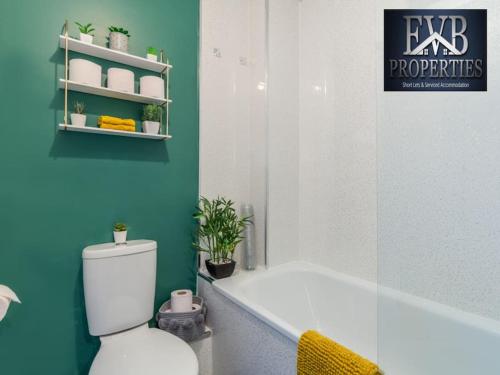 a bathroom with a tub and a toilet and a sink at Stylish Southampton Abode in Southampton