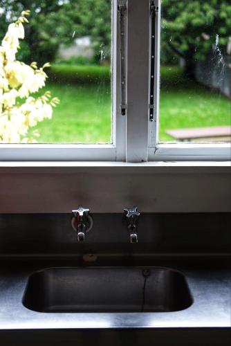 a kitchen sink in front of a window at Orla's Cottage in Oamaru