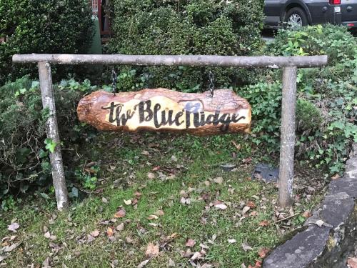 a sign that says the on a bench at Mountain Aire Cottages, Inn, & Glamping in Clayton