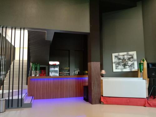 a lobby with a counter and a bar in a building at Onesouth Banyuwangi Pulau merah in Banyuwangi