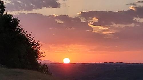 a sunset with the sun in the sky at La Covatilla III in La Hoya