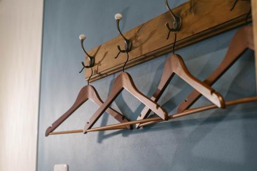 a group of wooden hangers hanging from a wall at 7 Rooms Hotel & Cafe - 30mins from Disneyland in Tokyo