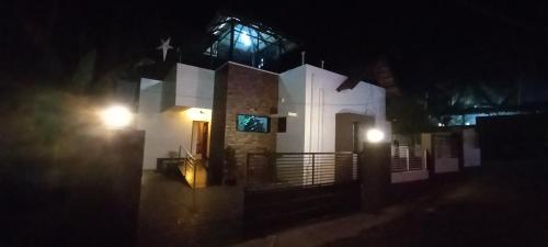 a white church at night with lights on it at Eka Homes 3BHDK Villa in Trivandrum
