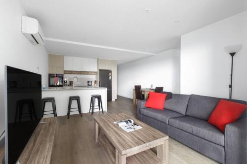 a living room with a couch and a table at Resort Style Living In the Heart of Moonee Ponds in Melbourne