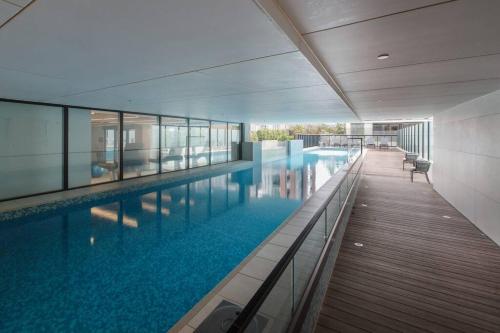 a large swimming pool in the middle of a building at Resort Style Living In the Heart of Moonee Ponds in Melbourne