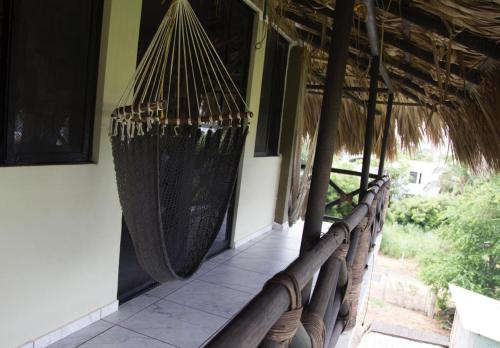 a group of hammocks hanging from a building at Beach Front Guesthouse in Puerto Escondido