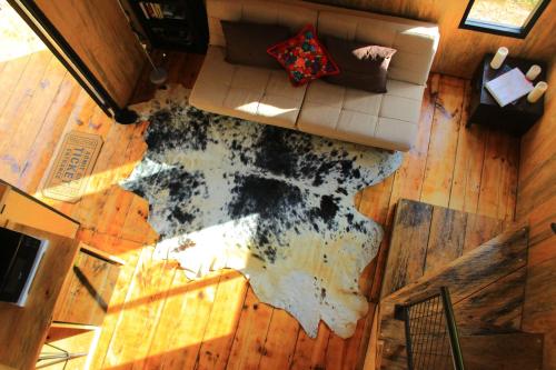 an aerial view of a living room with a rug on the floor at Tiny House with trekking circuit in San Cristóbal de Las Casas