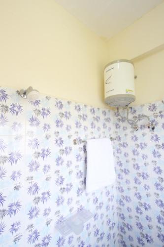 a bathroom with a toilet and a towel at Lakshana Service Apartment - Big Temple Thanjavur in Thanjāvūr
