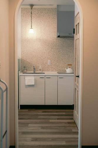 a kitchen with a sink and a counter top at 7 Rooms Hotel & Cafe - 30mins from Disneyland in Tokyo