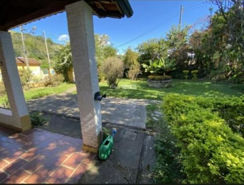 a toy duck is sitting on the porch of a house at Passa Quatro- CASA INTEIRA RUSTICA para até 9 pessoas in Passa Quatro