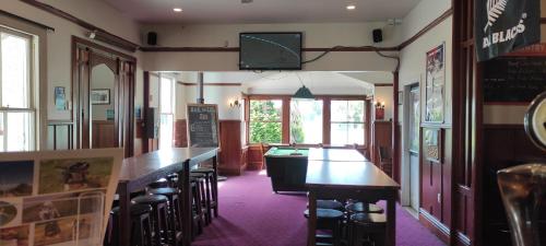 a bar with tables and stools in a restaurant at South Rakaia Hotel in South Rakaia