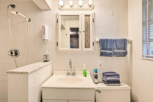 a white bathroom with a sink and a mirror at Central and Cozy Studio Shop, Swim and Explore! in Lake Worth