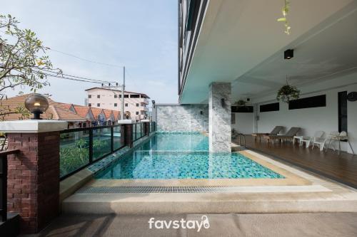 a pool of water with a swimming pool at The Corner Lodge - SHA Extra Plus in Pattaya Central