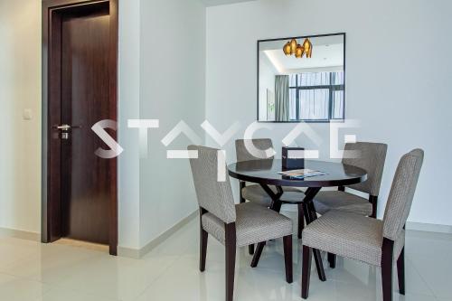 a dining room with a table and chairs and a mirror at Staycae Holiday Homes - Celestia in Dubai