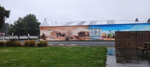 a building with a mural on the side of it at South Rakaia Hotel in South Rakaia