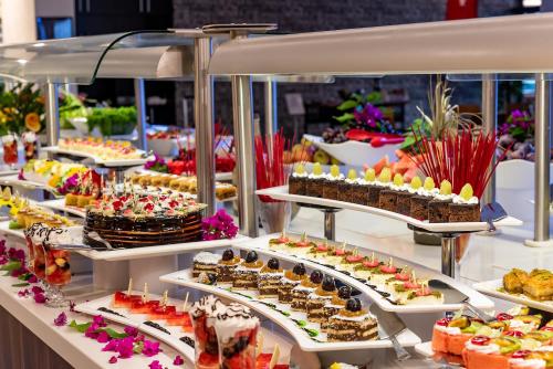 a buffet with many different types of desserts on display at White City Beach Adult Only in Konaklı