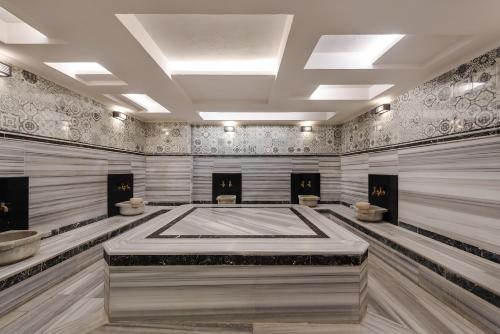 a large room with three toilets in the middle at White City Beach Adult Only in Konaklı