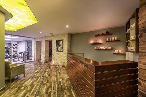 a bar with a wooden counter in a room at White City Beach Adult Only in Konaklı