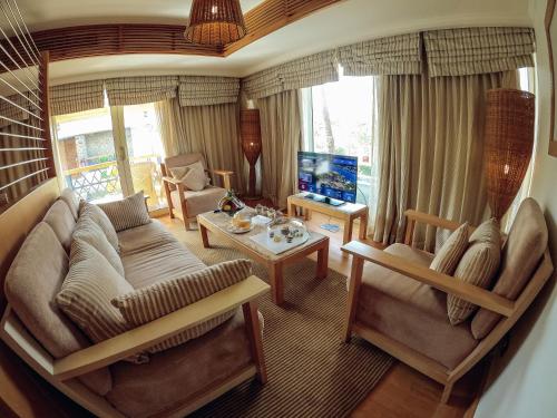 a living room with a couch and a table at Mövenpick Resort Aswan in Aswan