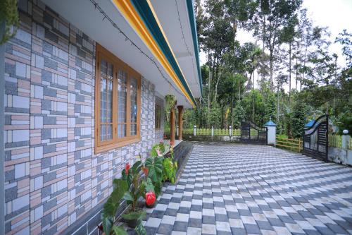 a patio with plants on the side of a building at Arabian Nights Munnar Pool Villa in Munnar