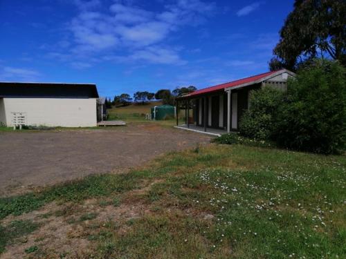 a building with a grass field and a yard at Swansea Backpackers in Swansea