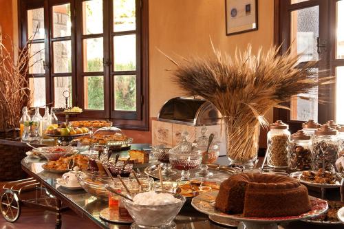 a table filled with different types of food at Katogi Averoff Hotel & Winery in Metsovo