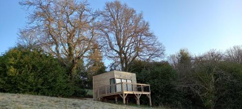 a small wooden house on a hill with trees at Demeure de la Garenne in Montmirail
