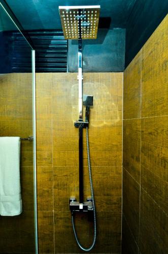 a shower with a shower head in a bathroom at Pine Hill Residence in Kandy
