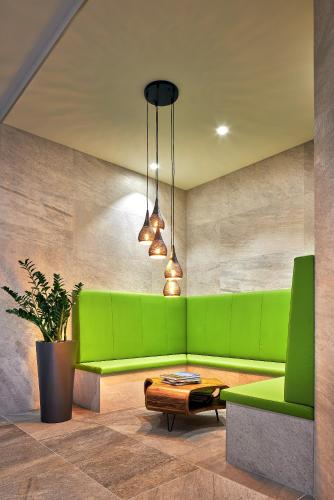 a living room with a green couch and a table at ever grün KAPRUN in Kaprun