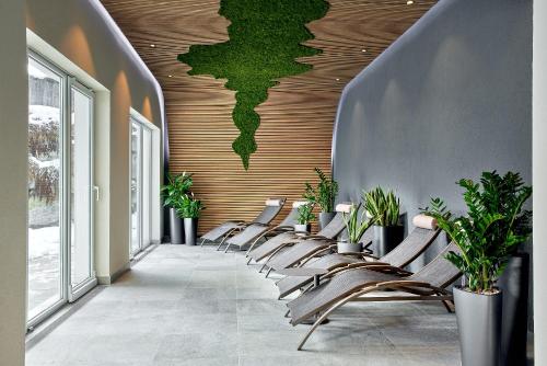 a row of chairs lined up against a wall with a mural at ever grün KAPRUN in Kaprun