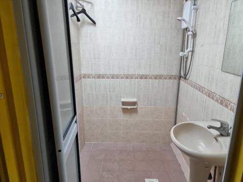 a bathroom with a shower and a sink at Darlene Hotel in Singapore