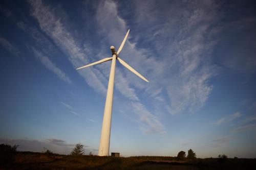 a large wind turbine in a field with a sky at Skarrildhus Sinatur Hotel & Konference in Skarrild