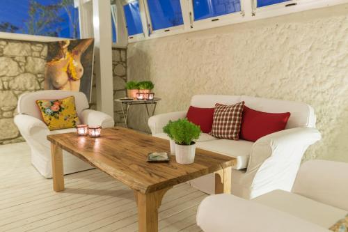 a living room with white furniture and a wooden table at LuCe Design Hotel - Special Category in Alacati