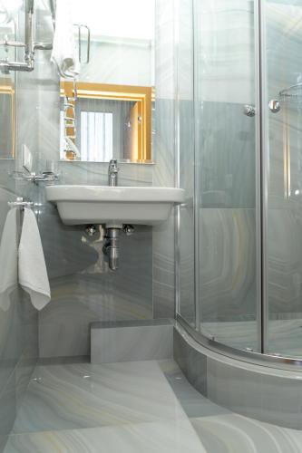a bathroom with a sink and a shower at Light Hotel in Dnipro