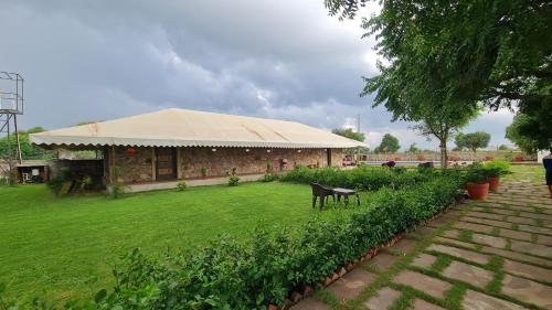 a building with a tent on top of a yard at The Rustic Villa, a stay with luxuries amenities and exotic nature in Jaipur