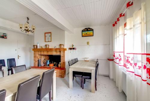 jadalnia ze stołem i kominkiem w obiekcie La ferme d'Odette Gîte et salle de reception w mieście Poucharramet