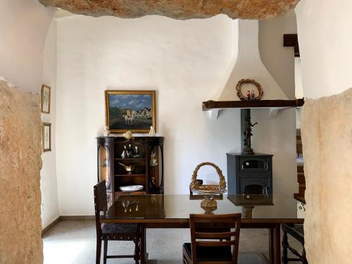 a dining room with a table and a wood stove at Villa Pedra Natural Houses in Alvorge