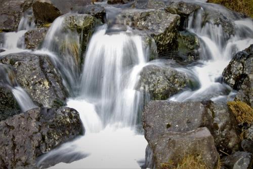 a stream of water flowing over rocks at Ægisholt privete house with hot tub in Patreksfjörður