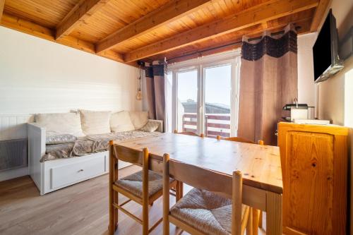 un salon avec une table en bois et un canapé dans l'établissement Le Sommet, à Font-Romeu-Odeillo-Via