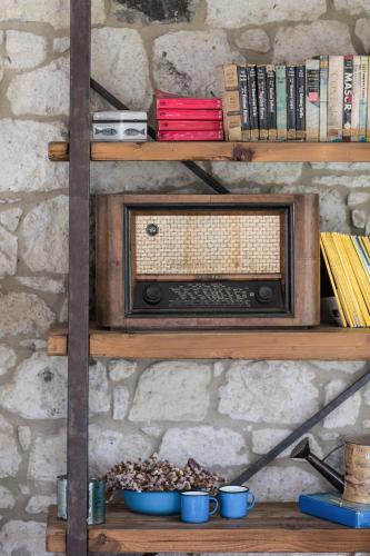 a shelf with a radio on a stone wall at LuCe Design Hotel - Special Category in Alacati