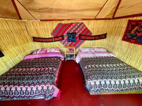 a room with two beds in the middle of it at Uros Lodge Lover Titiqaqa in Puno