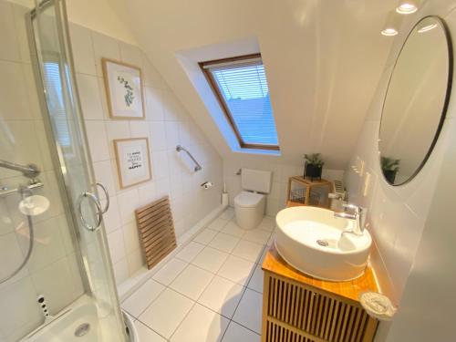 a bathroom with a sink and a shower at Kieler FeWo No.1 in Kiel