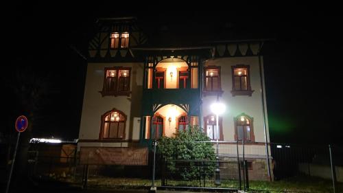 a building with a light on the side of it at night at Villa Weißbach - Haus Hilda in Flöha