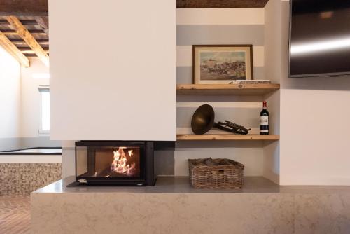 a fireplace in a living room with a fire place at Relais Barchessa Molon in Campo di Pietra