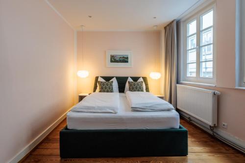 a bedroom with a large bed with two pillows at Apartment Zentral in Tübingen